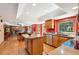 Open kitchen features stainless appliances, island, hardwood floors, and abundant natural light at 12752 W Dakota Ave, Lakewood, CO 80228