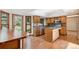 Well-lit kitchen featuring wood cabinetry, a functional island, and hardwood floors at 12752 W Dakota Ave, Lakewood, CO 80228