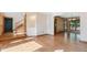 Inviting living space with hardwood floors, showcasing a staircase and an open transition to the dining area at 12752 W Dakota Ave, Lakewood, CO 80228