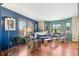 Bright living room with hardwood floors, large windows, and a cozy seating area at 12752 W Dakota Ave, Lakewood, CO 80228