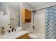 Well-lit bathroom featuring a marble vanity, stylish fixtures, and a shower with a blue patterned curtain at 9879 Saybrook St, Highlands Ranch, CO 80126