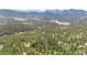 Breathtaking aerial view of a mountain community surrounded by lush greenery and a serene lake at 4992 White House Trl, Evergreen, CO 80439