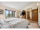 Spacious bedroom with an ensuite bathroom and windows providing natural light and scenic views at 4992 White House Trl, Evergreen, CO 80439