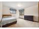 A cozy bedroom features carpeted floors, a large window, and comfortable decor at 4992 White House Trl, Evergreen, CO 80439