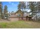 Inviting two-story home with a two car garage nestled among mature trees at 4992 White House Trl, Evergreen, CO 80439