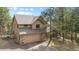 Charming two-story home with a two car garage, stone accents, and mature trees at 4992 White House Trl, Evergreen, CO 80439