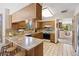 A spacious kitchen with granite countertops, tile backsplash, and ample cabinetry, seamlessly connecting to the dining area at 4992 White House Trl, Evergreen, CO 80439