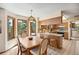 Charming kitchen with granite countertops and bar seating, flows into the adjacent dining area for convenient entertaining at 4992 White House Trl, Evergreen, CO 80439