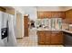 A spacious kitchen with stainless steel refrigerator and granite countertops, seamlessly flows into living spaces for easy entertaining at 4992 White House Trl, Evergreen, CO 80439