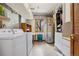 Basement laundry room with washer, dryer, shelving, and utility sink at 4992 White House Trl, Evergreen, CO 80439