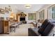 A cozy living room includes piano, media center, and leather sofas, designed for relaxation and comfortable living at 4992 White House Trl, Evergreen, CO 80439