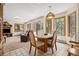 Open-concept living space featuring dining and living areas, enhanced by large windows that bring the outdoors in for year-round enjoyment at 4992 White House Trl, Evergreen, CO 80439