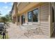 Outdoor stone patio area with table and chairs perfect for entertaining, and barbecue grill at 4992 White House Trl, Evergreen, CO 80439