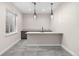 Stylish bar area features pendant lights, a breakfast bar, and gray tiled floors at 8014 Trinity Peak Ln, Castle Rock, CO 80108