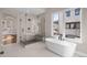 Spa-like bathroom retreat with glass-enclosed shower, soaking tub, and serene natural light at 8014 Trinity Peak Ln, Castle Rock, CO 80108