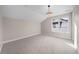 Bright bedroom with vaulted ceiling and modern light fixture at 8014 Trinity Peak Ln, Castle Rock, CO 80108