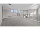 Light-filled bonus room features plush carpeting, black metal railing, and expansive windows with lovely views at 8014 Trinity Peak Ln, Castle Rock, CO 80108