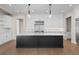 Modern kitchen featuring white cabinets, a large island with marble countertops, and pendant lighting at 8014 Trinity Peak Ln, Castle Rock, CO 80108