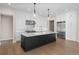 Modern kitchen with stainless steel appliances, white cabinets, and a large marble island at 8014 Trinity Peak Ln, Castle Rock, CO 80108