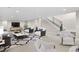 Bright living room featuring a modern staircase, neutral color palette, and stylish decor at 8014 Trinity Peak Ln, Castle Rock, CO 80108
