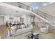 Open-concept living space featuring a modern staircase, sleek railings, and contemporary decor at 8014 Trinity Peak Ln, Castle Rock, CO 80108