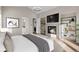 Relax in this bedroom with a cozy fireplace, TV, modern shelving, and peaceful ambiance at 8014 Trinity Peak Ln, Castle Rock, CO 80108