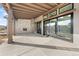 Covered outdoor patio area with stone fireplace and sliding glass doors providing ample natural light at 8014 Trinity Peak Ln, Castle Rock, CO 80108
