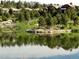 Picturesque waterfront view by a pond with flower beds at 8014 Trinity Peak Ln, Castle Rock, CO 80108