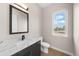 Elegant powder room featuring a sleek marble countertop and modern fixtures at 8014 Trinity Peak Ln, Castle Rock, CO 80108