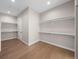 Spacious walk-in closet with built-in shelving and wood flooring, providing ample storage space at 8014 Trinity Peak Ln, Castle Rock, CO 80108