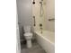 Bathroom featuring a toilet, bathtub, and shower with updated fixtures at 1011 S Ironton St # 107, Aurora, CO 80012
