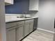 The kitchen features new cabinets and quartz countertops. Modern stainless steel sink and appliances at 1011 S Ironton St # 107, Aurora, CO 80012