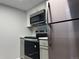 Updated kitchen features stainless steel appliances, white cabinets, and marble-look countertops at 1011 S Ironton St # 107, Aurora, CO 80012