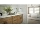 Bathroom with double vanity, wood cabinets, and modern fixtures at 21004 E 63Rd Dr, Aurora, CO 80019