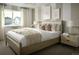 Stylishly decorated bedroom featuring soft textures, a neutral color scheme, and a large window at 21004 E 63Rd Dr, Aurora, CO 80019