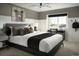 Modern bedroom design with a sleek black bed frame, a desk, and a large window view at 21004 E 63Rd Dr, Aurora, CO 80019