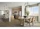 Open concept kitchen with a dining area, stainless steel appliances, and modern light fixtures at 21004 E 63Rd Dr, Aurora, CO 80019