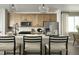 Bright kitchen with modern appliances, light wood cabinets, and a quartz countertop island at 21004 E 63Rd Dr, Aurora, CO 80019