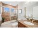 Bright bathroom featuring tiled shower, granite countertops, and modern fixtures at 3375 N Willow St, Denver, CO 80238