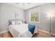 Cozy bedroom with a comfortable bed, white bedding, and natural light from a large window at 3375 N Willow St, Denver, CO 80238