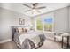Comfortable bedroom with a ceiling fan and ample natural light from the window at 3375 N Willow St, Denver, CO 80238