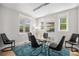 Bright dining room featuring a glass table, modern lighting, and a vibrant blue rug at 3375 N Willow St, Denver, CO 80238