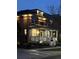 Beautiful brick home with a covered front porch illuminated by warm exterior lighting at dusk at 3375 N Willow St, Denver, CO 80238