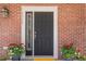 Charming front door with brick facade and beautiful potted plants at 3375 N Willow St, Denver, CO 80238