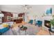 Open-concept living room featuring hardwood floors, a fireplace, and seamless flow to the kitchen at 3375 N Willow St, Denver, CO 80238