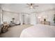 Bright main bedroom with a sitting area, ceiling fan, and plush carpeting at 3375 N Willow St, Denver, CO 80238