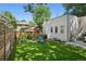 Green backyard featuring a play set, a wood fence, and ample space at 2377 S Humboldt St, Denver, CO 80210