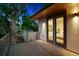 Outdoor balcony with a wood deck, metal railings, and exterior lighting at 2377 S Humboldt St, Denver, CO 80210