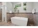 Stylish bathroom featuring a soaking tub, tile flooring, and designer fixtures at 2377 S Humboldt St, Denver, CO 80210