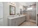 Modern bathroom with double sinks, quartz counters, and a glass enclosed shower at 2377 S Humboldt St, Denver, CO 80210